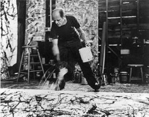 One of Namuth's many photos of Jackson Pollock painting with his drip method.